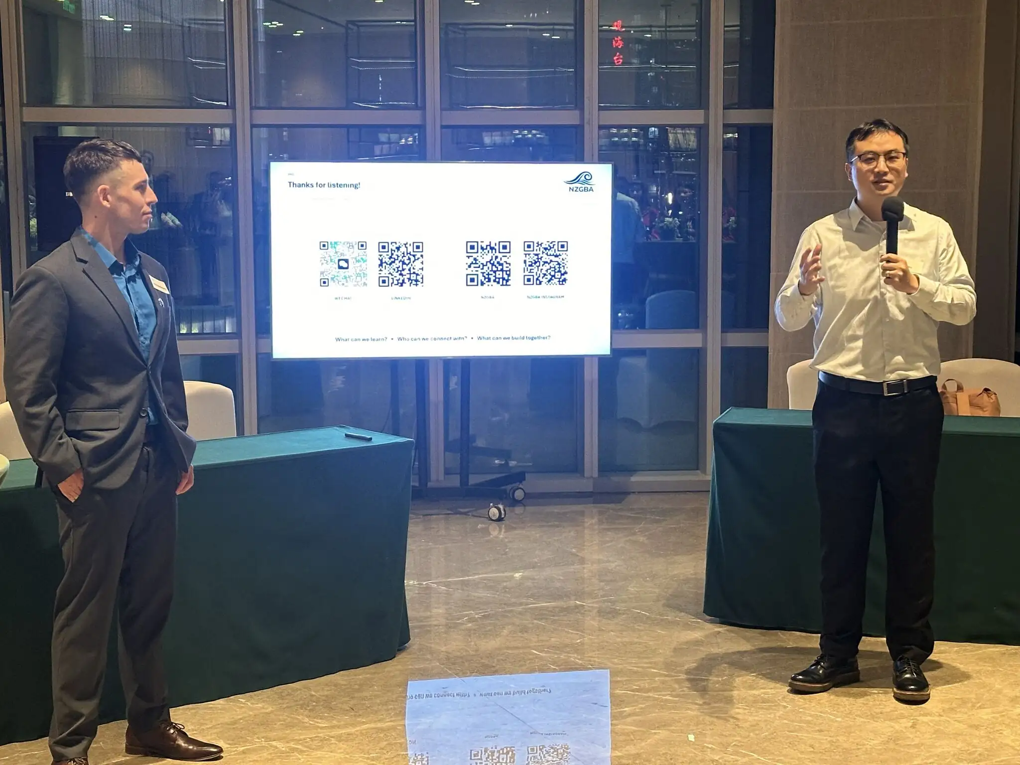Speakers beside the NZGBA presentation screen during the University of Auckland MBA discussion
